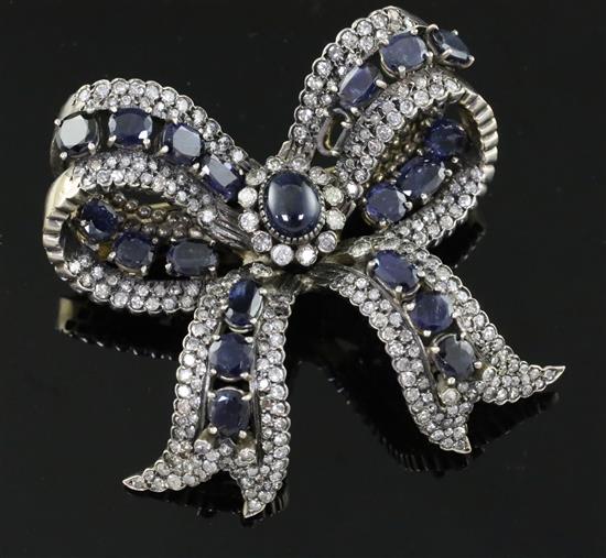 A 20th century gold, sapphire and diamond encrusted ribbon bow clip brooch,